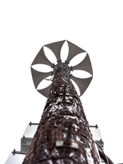 Looking up a weathered wood pole at several multi directional round amplified emergency siren or...