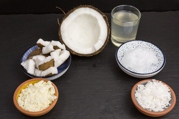 variety of coconut products: milk, puree, pieces, oil, flakes and pieces of coconut