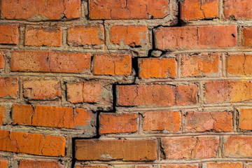 deep cracked orange brick wall closeup texture