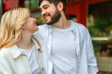 Attractive couple is looking each other while walking