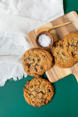 Homemade Salted Chocolate Chip Cookies on Colorful Green Background, Styled Flat Lay Dessert 