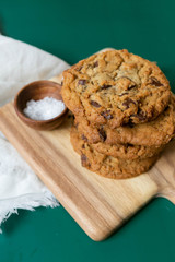 Homemade Salted Chocolate Chip Cookies on Colorful Green Background, Styled Flat Lay Dessert 