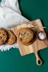 Homemade Salted Chocolate Chip Cookies on Colorful Green Background, Styled Flat Lay Dessert 