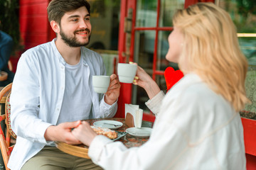 Happy loving couple enjoying date in outdoor cafe