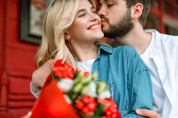 Happy lady enjoying of flowers from man