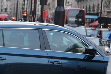 blue car stuck in traffic jam in London's West End