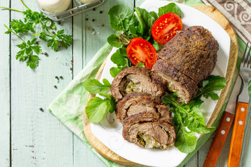 Stuffed Meat Roll with Pear and Cheese on a festive Thanksgiving Day table. Flat lay. Top view. Copy space.