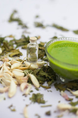 Neem or Indian Lilac face mask isolated on a white surface for skin infection of neem leaves paste, garlic cloves and coconut oil.