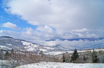 Fototapeta na wymiar View of the Carpathian mountains covered with snow in a winter sunny frosty day