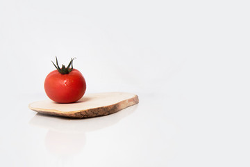 a red tomato on table and wood