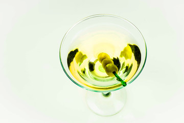 Martini glass with green olives