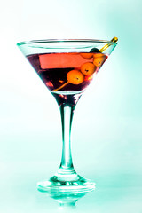 Martini glass with green olives