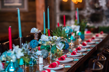 table with tableware at the bar is beautifully set with red candles and for a night celebration party.
