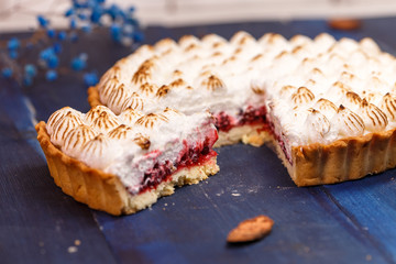 Freshly baked homemade berry pie on a wooden dark blue table