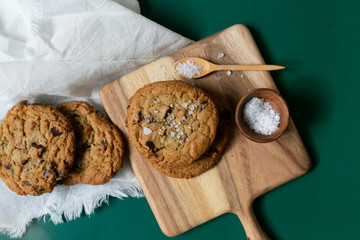 Homemade Salted Chocolate Chip Cookies on Colorful Green Background, Styled Flat Lay Dessert 