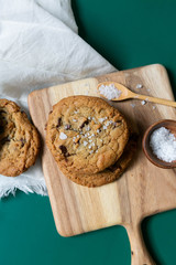 Homemade Salted Chocolate Chip Cookies on Colorful Green Background, Styled Flat Lay Dessert 