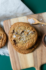 Homemade Salted Chocolate Chip Cookies on Colorful Green Background, Styled Flat Lay Dessert 