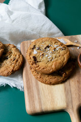 Homemade Salted Chocolate Chip Cookies on Colorful Green Background, Styled Flat Lay Dessert 