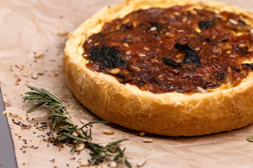  Freshly baked vegetarian pie homemade on craft paper.