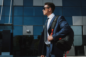 Young executive is going to work with backpack