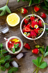 Fresh Strawberry lemonade on rustic wooden table. Top view flat lay background. Free space for your text.