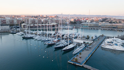 Fototapeta na wymiar Aerial view of the pier with yachts and boats in the city of Valencia, Spain. Drone photography.
