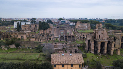 Fototapeta na wymiar Aerial view of the ancient remains of buildings in the historic city of Rome, Italy. Drone photography
