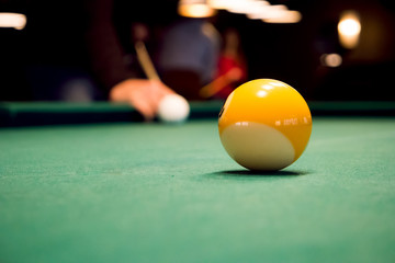 Man playing billiard indoors, nightlife and sport concept