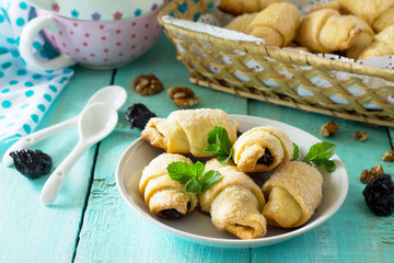 Homemade cookies with dried prunes and walnuts on a rustic wooden table.