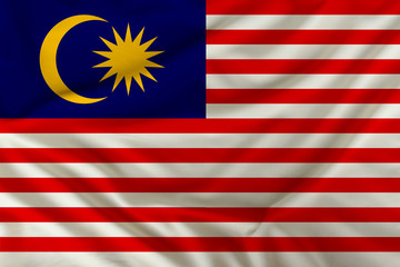 national flag of Malaysia on a silk cloth with folds from the wind, a symbol of tourism, immigration, political asylum