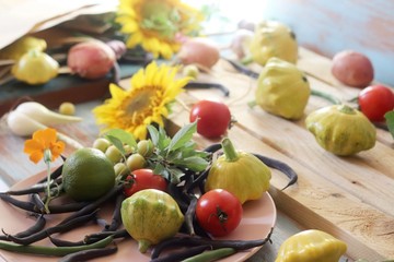 Bright fresh vegetables, fruits and flowers on a wooden table, healthy food, the season of summer, autumn