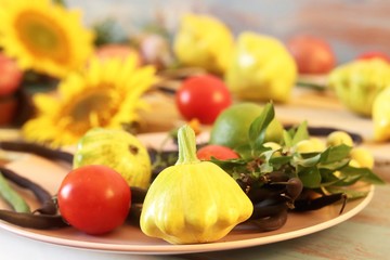 Bright fresh vegetables, fruits and flowers on a wooden table, healthy food, the season of summer, autumn