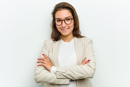 Young european business woman smiling confident with crossed arms.