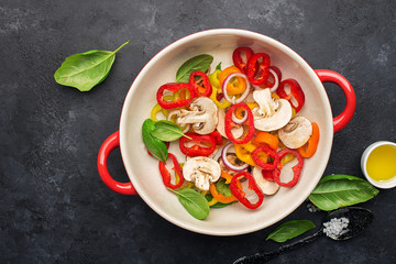 Healthy food. Fresh vegetables, bell peppers capsicum, olives, onions, basil, mozzarella cheese. In a ceramic dish before cooking. Ingredients for frittata, scrambled eggs, grilled vegetables, fresh