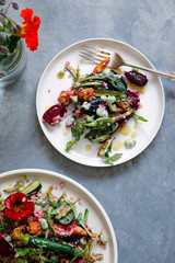 Bulgur wheat salad with roast beetroots, carrots, zucchini and green peas