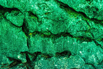 green colored stratified rock formation full frame