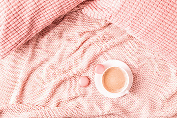 Background with pink plaid, coffee and macaroons.