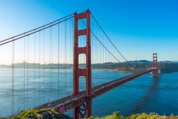 Golden Gate Bridge at sunrise and blue sky in San Francisco , USA