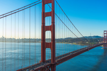 Golden Gate Bridge at sunrise and blue sky in San Francisco , USA