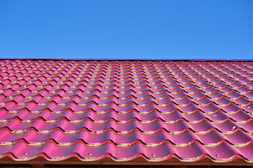 Fototapeta premium metal shingles on the roof of the house on a Sunny day