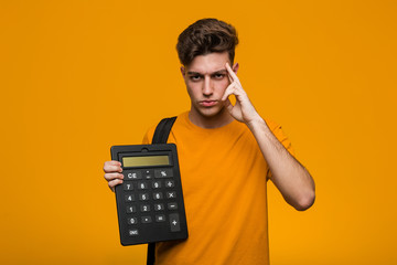 Young student man holding a calculator trying to listening a gossip.
