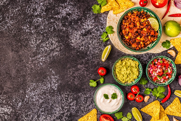 Mexican food concept: tortillas, nachos with guacamole, salsa.