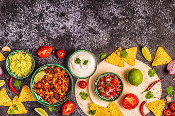 Mexican food concept: tortillas, nachos with guacamole, salsa.