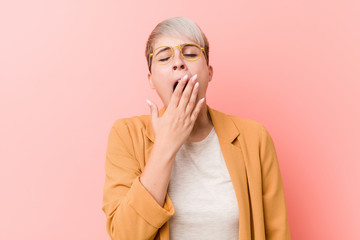 Young caucasian woman wearing a casual business clothes yawning showing a tired gesture covering mouth with hand.