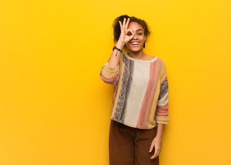 Young black african american girl with blue eyes confident doing ok gesture on eye