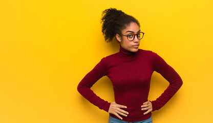 Young black african american girl with blue eyes scolding someone very angry