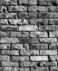 Desaturated brick wall background. Grunge old black and white brickwork copy space wall grunge vintage texture. 