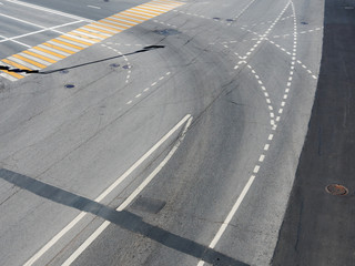 Road markings on the asphalt. Painted signs on the roadway and pedestrian crosswalk. Dotted line and arrows. Moscow, Russia.