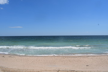 Sunny Bulgarian beach tranquil landscape. Empty coastline on the shore of the Black Sea, Shabla. Perfect place for relaxation on the summer sunny weekends. Clean water and blue sky seascape.