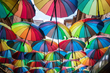Many colorful umbrellas above the street
